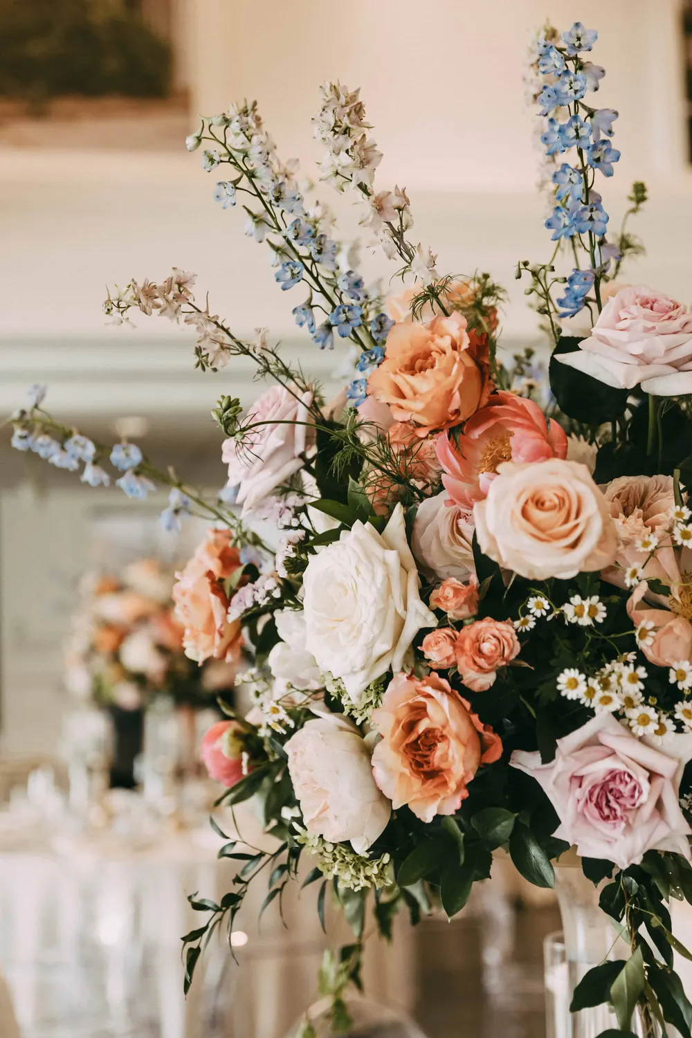 Peach, white and blue garden-style arrangement