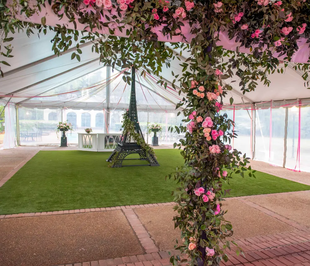 Tent pole wrapped in climbing florals for a Paris-themed party